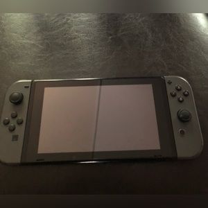 A working Nintendo with black joy cons.